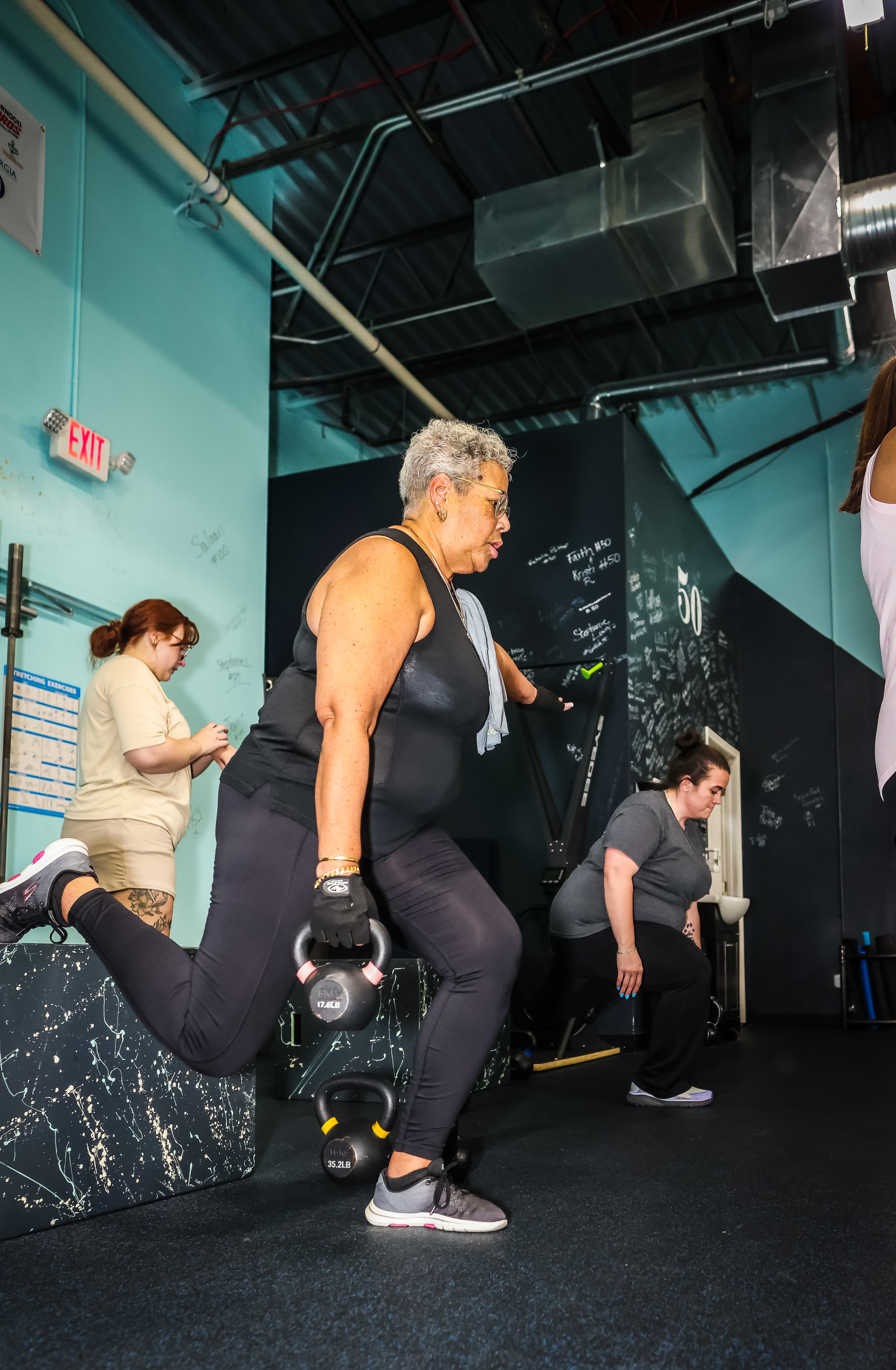 Kettlebell lunges in a Grit Life class