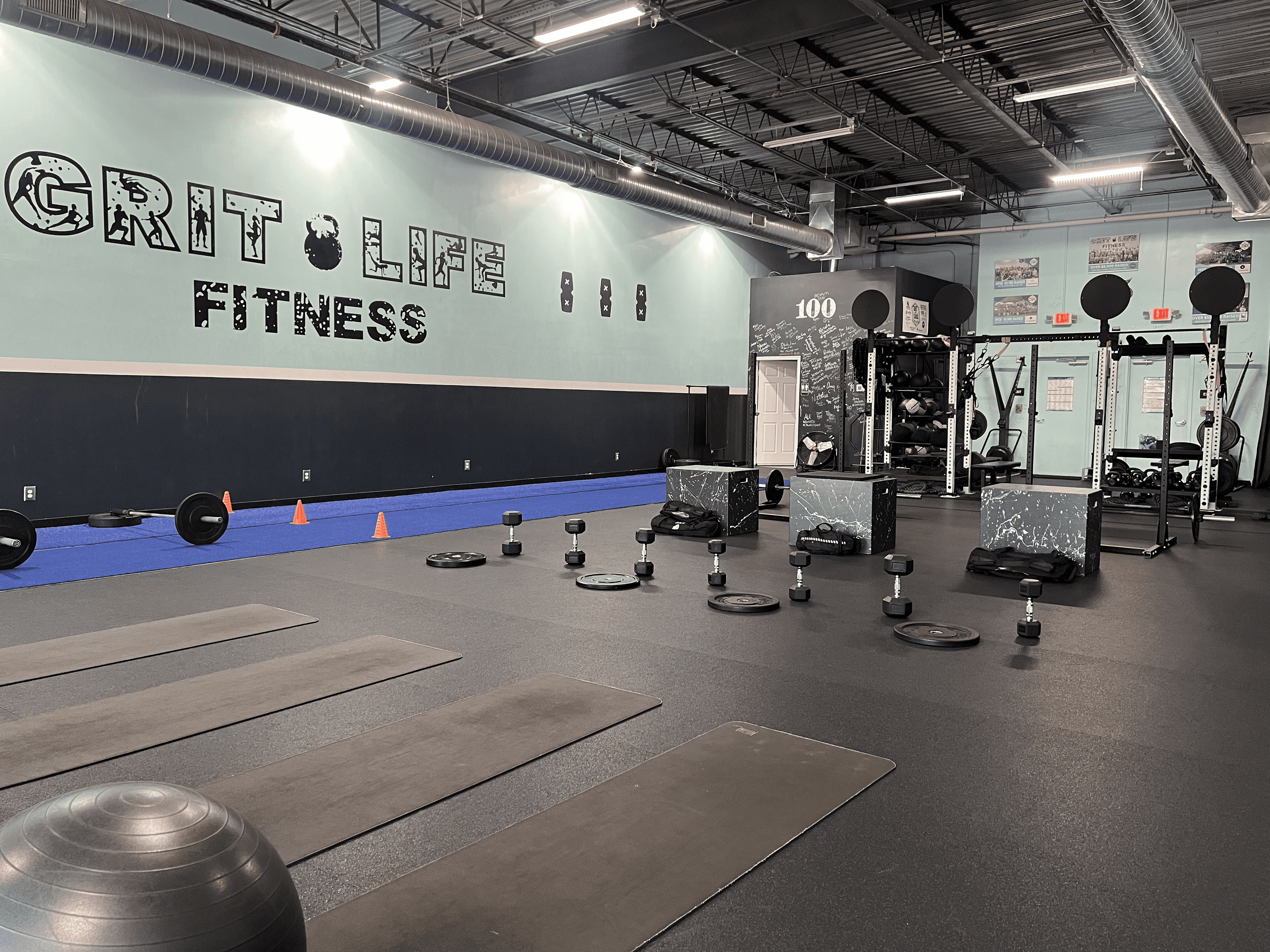 Squat racks and turf at Grit Life Fitness