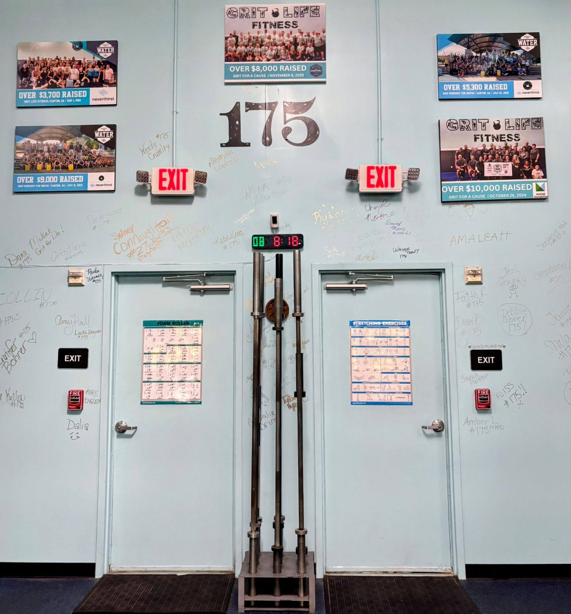 Grit Life Fitness wall showing past Grit for a Cause fundraising totals