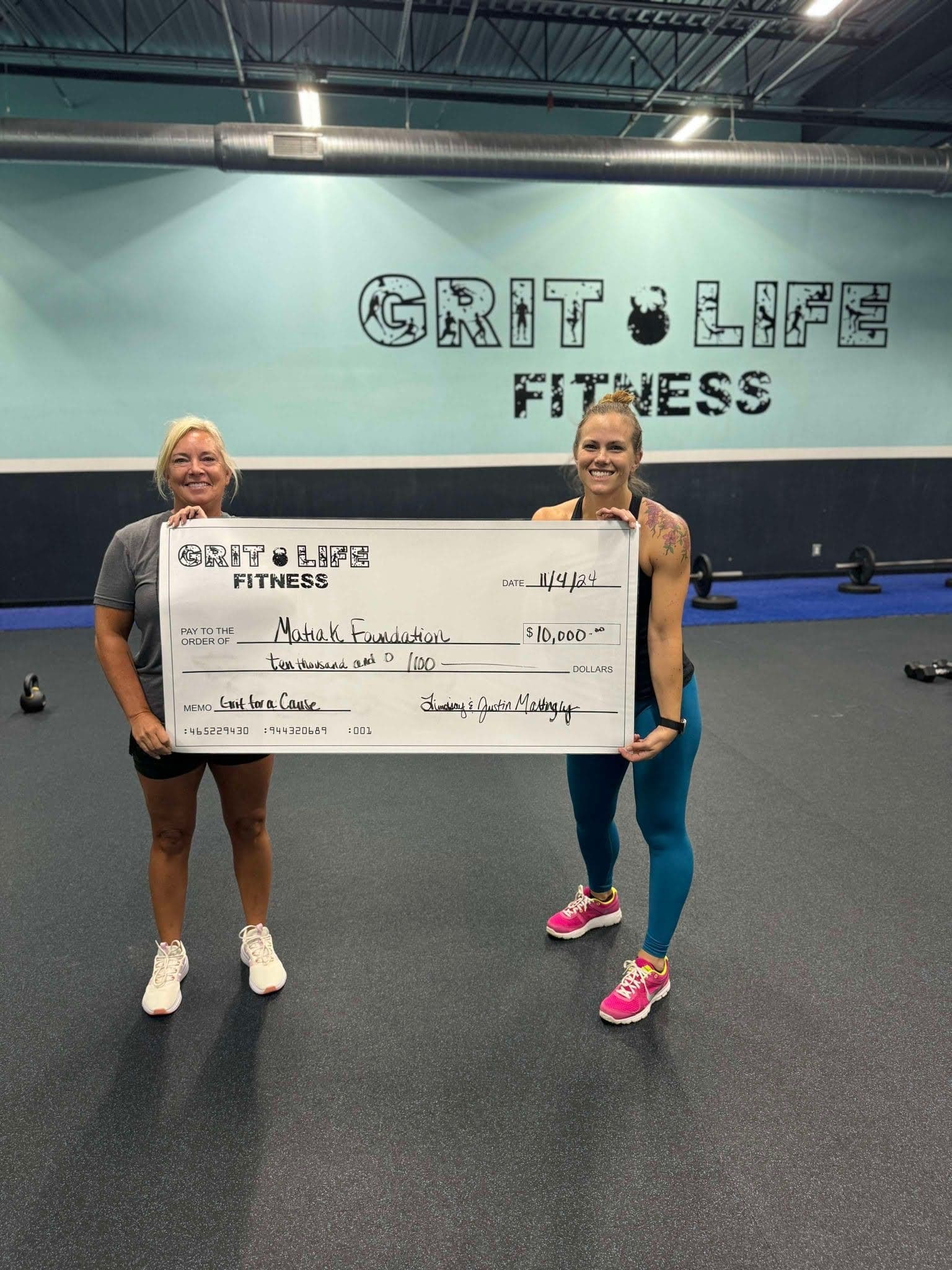 Grit Life Fitness presenting a $10,000 cheque raised through Grit for a Cause