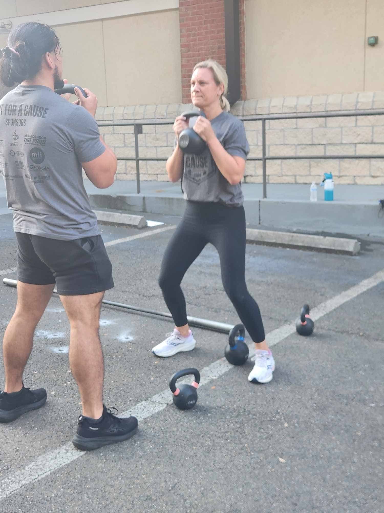 A participant holding a kettlebell in the front rack position during the challenge
